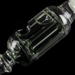 Clear glass bubbler with intricate swirling design, isolated on black.