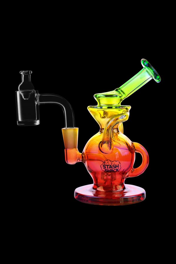 A colorful glass dab rig with a quartz banger, isolated on a black background.