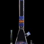 A tall, ornate glass bong with blue and colorful accents, displayed with a glass slide and downstem against a black background.