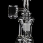 Clear glass dab rig with a quartz banger, isolated on a black background.