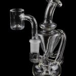 Clear glass dab rig with intricate percolators, isolated on a black background.
