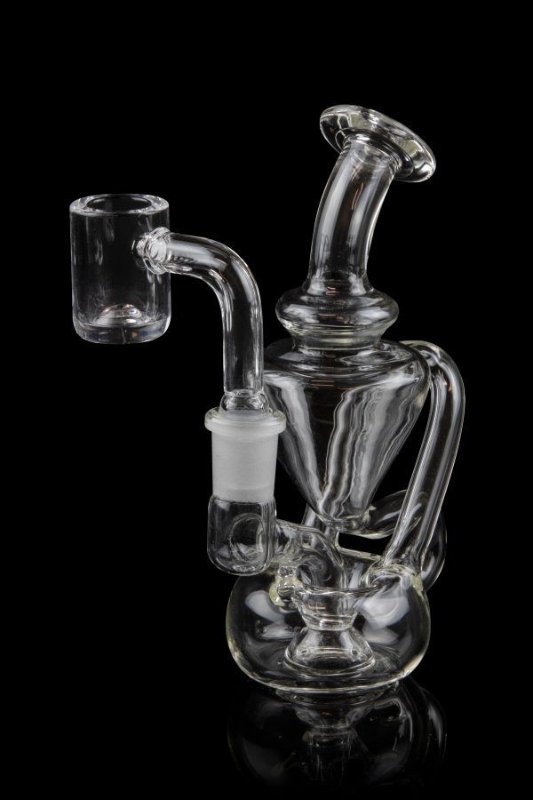 Clear glass dab rig with intricate percolators, isolated on a black background.