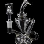Clear glass water pipe (rig) with intricate bubbler design and separate bowl piece, isolated on black.