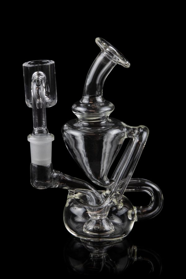 Clear glass water pipe (rig) with intricate bubbler design and separate bowl piece, isolated on black.