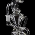 Clear glass water pipe (rig) with intricate swirling design, isolated on a black background.
