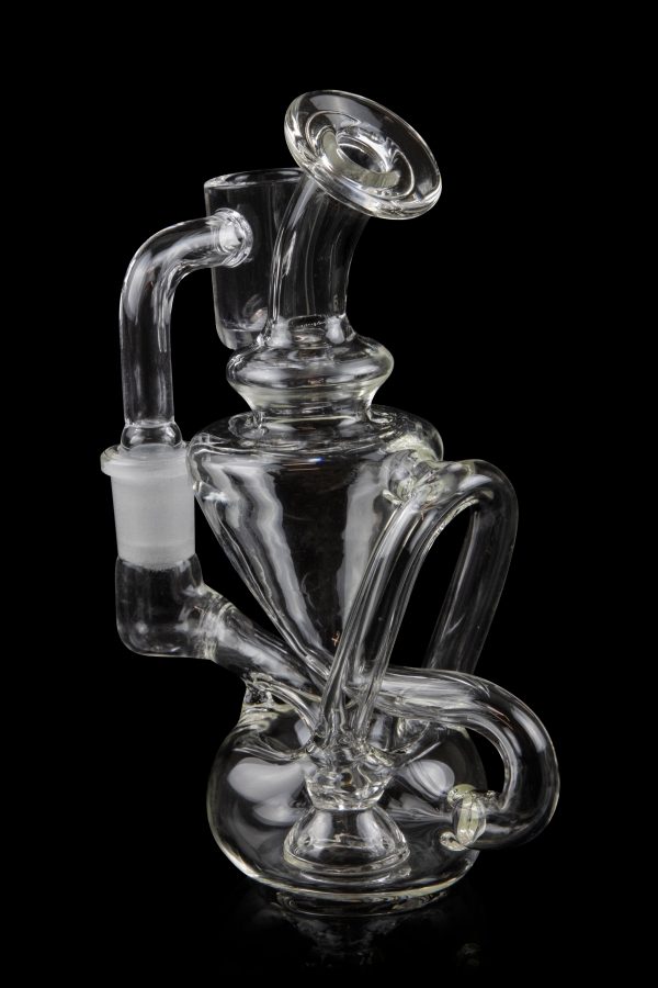 Clear glass water pipe (rig) with intricate swirling design, isolated on a black background.