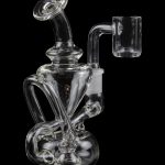 Clear glass dab rig with intricate bubbler design and quartz banger, isolated on black.