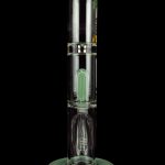 Green glass water pipe (bong) with percolators, isolated on a black background.