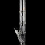 Clear glass water pipe (bong) with multiple filtration chambers and a detachable downstem, isolated on a black background.