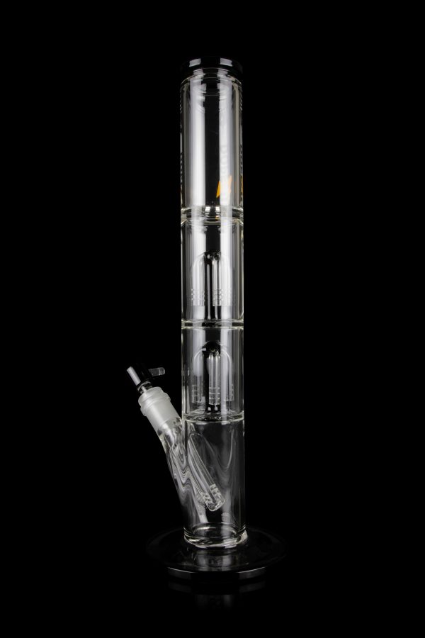 Clear glass water pipe (bong) with multiple filtration chambers and a detachable downstem, isolated on a black background.