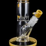 Glass water pipe (bong) with a yellow mouthpiece and base, featuring intricate internal diffusion details.