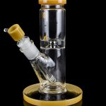 Glass water pipe with a beige mouthpiece and base, reflecting on a black surface.