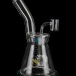 Clear glass water pipe (bong) with intricate percolator and accompanying glass bowl, isolated on a black background.