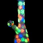 Glowing glass bong with colorful paw print design.
