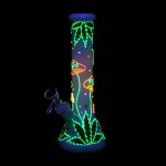 Neon green and orange cannabis leaf and mushroom designs on a glass bong, isolated on black.