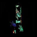 Neon cannabis and mushroom illustrations on a black glass smoking piece.