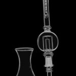 A close-up, angled view of the Pulsar Bubble Vapor Vessel with Quartz Tip & Stand, showcasing its clear glass construction and unique bulbous shape.