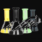 A front view of the Pulsar Mini Bi-Color Beaker Rig, displaying a colorful glass beaker on a black background.
