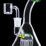 Glass water pipe (bong) with a quartz nail and colorful accents, isolated on a black background.