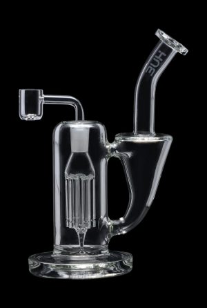 Clear glass dab rig with intricate percolator and quartz nail.