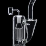 Clear glass dab rig with intricate percolator and quartz banger.