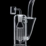 Clear glass dab rig with intricate percolator chamber, isolated on a black background.