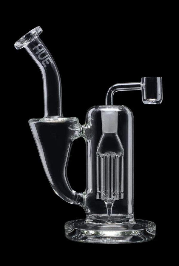 Clear glass dab rig with intricate percolator and quartz nail, isolated on a black background.