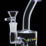 A side view of the Atomik Little Dipper Dab Rig, showing its clear glass construction and compact 5.25-inch size.