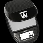 Digital scale with a carbon fiber platform, displaying 0.0 grams, used for precise cannabis measurement.