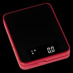 Red digital scale displaying 0.00 grams, used for measuring cannabis.