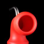 Red silicone oil rig bubbler with a glass downstem against a black background.