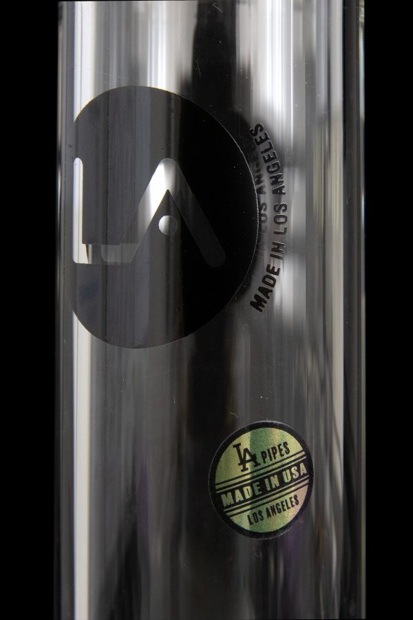 Close-up of a stainless steel pipe with a circular label reading “LA PIPES MADE IN USA LOS ANGELES”.