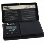 A close-up, angled view of the MyWeigh Triton T2 120g scale, displaying instructions on its open lid.