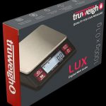 A close-up, angled view of the Lux Digital Mini Scale with a black face and silver body, displaying a digital readout.