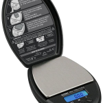 A close-up, angled view of the Truweigh Sonic Digital Mini Scale, displaying a digital readout on its black surface.