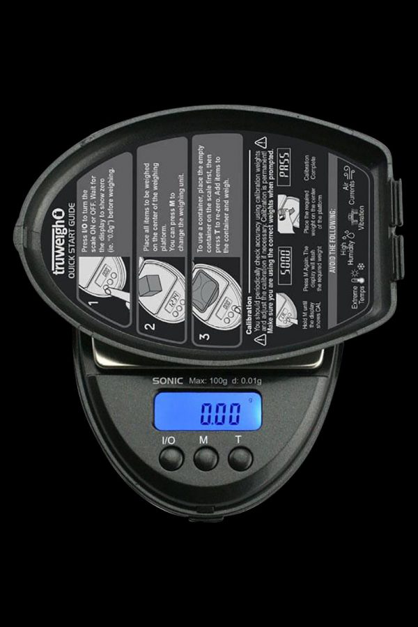 Close-up of the Truweigh Sonic Digital Mini Scale displaying a zero reading, with instructional text visible on its surface.