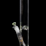 Green-accented glass bong with intricate bubble detailing.