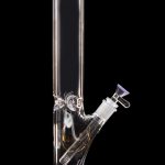 Purple-tinted glass bong with ice catcher, isolated on black.