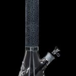 Tall glass bong with geometric patterns and intricate etching, isolated on a black background.