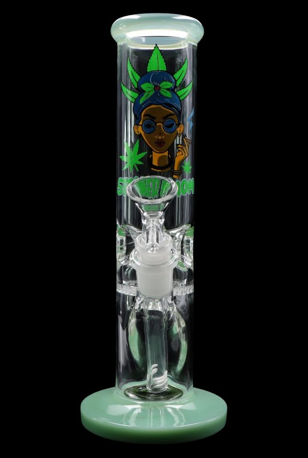 A vibrant green glass water pipe (bong) with a cartoon illustration of a woman wearing sunglasses and a headwrap, surrounded by cannabis leaves.