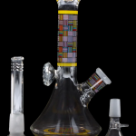 Glass bong with colorful patterned accents and accompanying downstem and bowl.