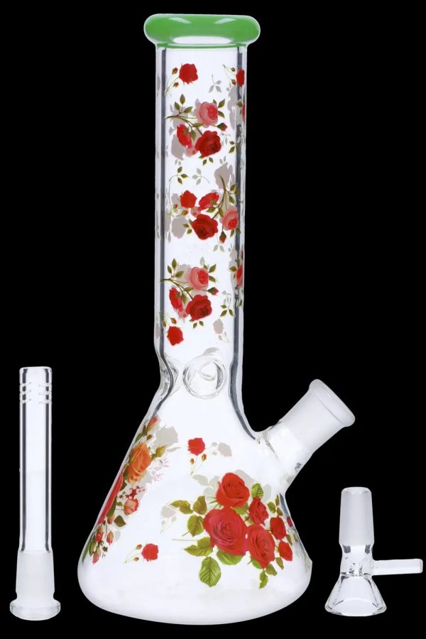 A glass bong decorated with red roses, alongside a glass downstem and bowl.