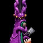 Purple glass octopus-shaped water pipe with orange claws and green accents, isolated on black.