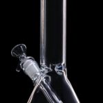 Clear glass bong with blue accents isolated on a black background.