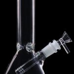 Clear glass bong with green accents against a black background.