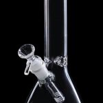 Clear glass bong with percolator, isolated on black.
