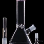 Glass bong with downstem and bowl, isolated on a black background.