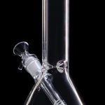 Clear glass bong with a diffused downstem, isolated on a black background.