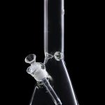 Clear glass bong against a black background.