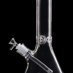 Clear glass bong with ice catcher, isolated on black.